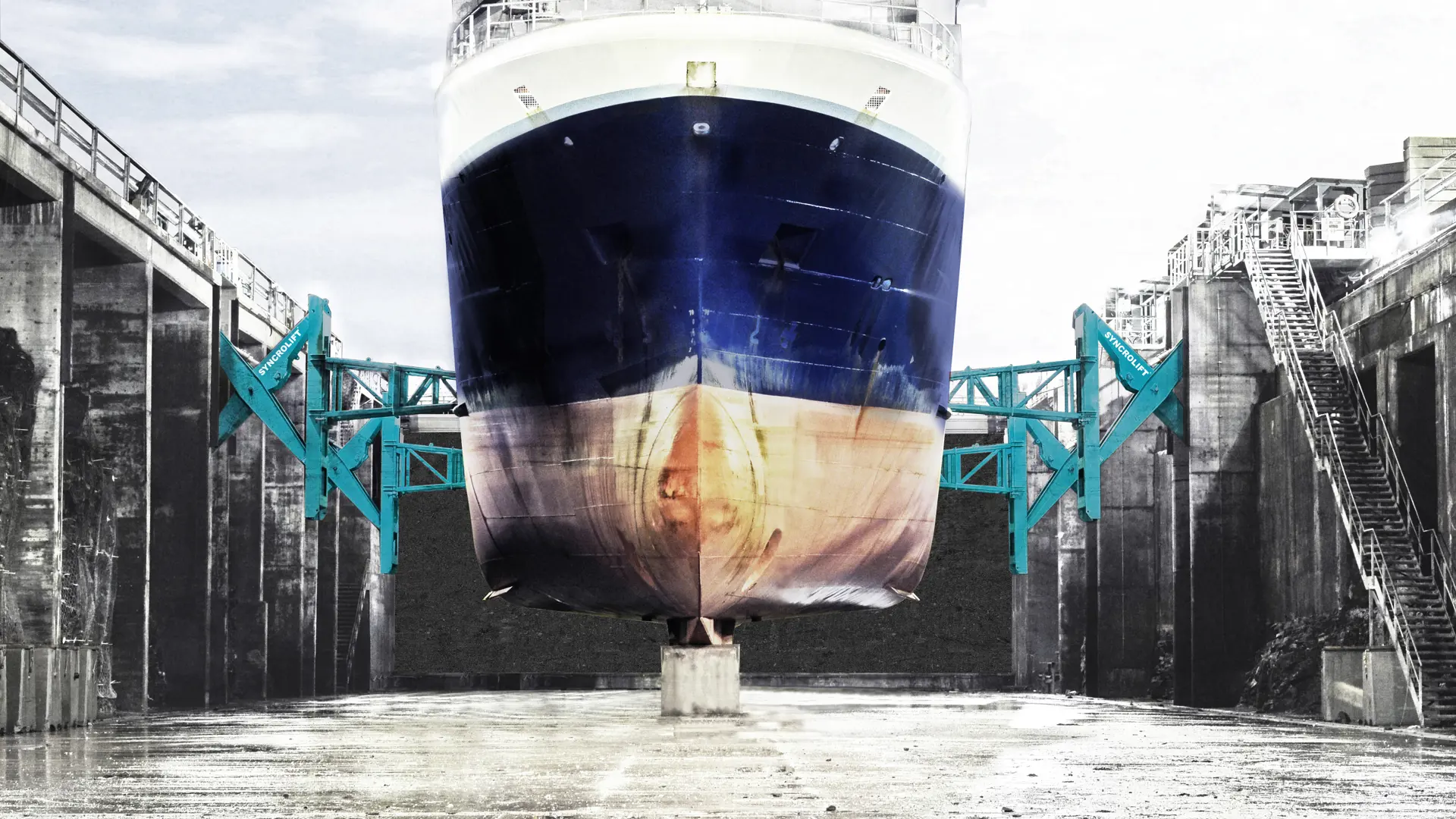 Dry dock side support arms stabilizing ship at Harstad shipyard